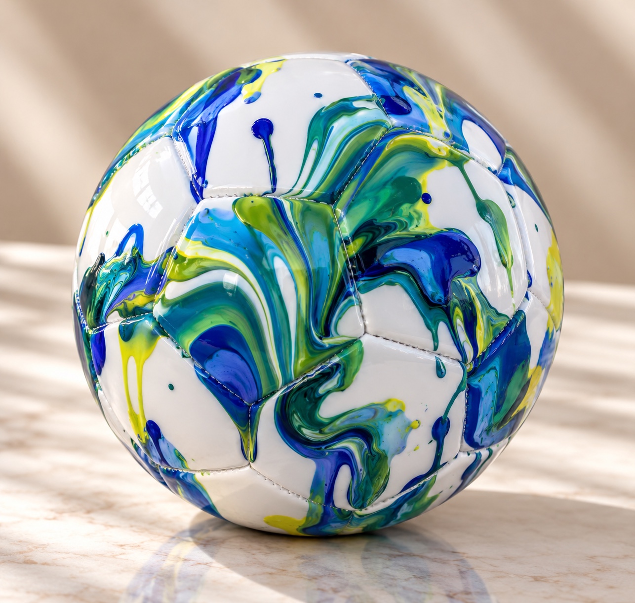 Blue and green drip painted soccer ball